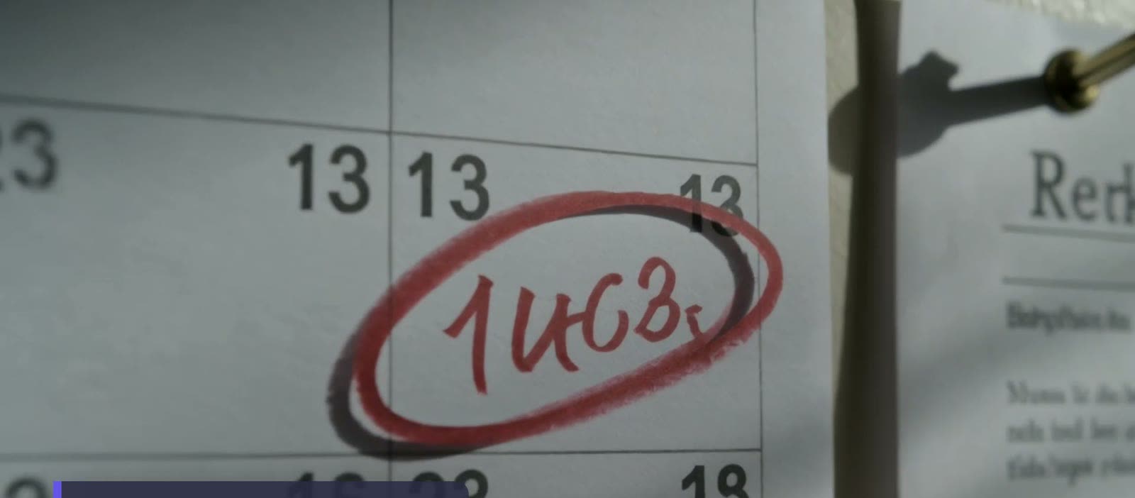 A wall calendar with dates ringed in red marker.